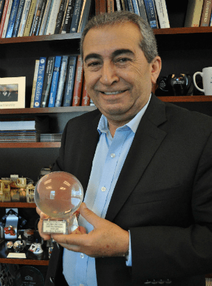 A man holding a glass ball in his hand.