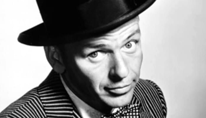 A man in a top hat and striped jacket.