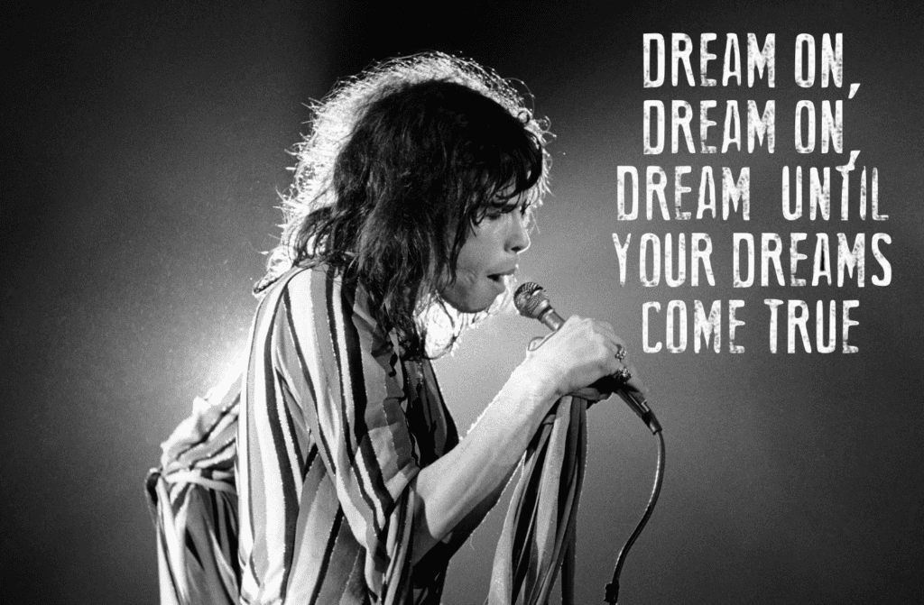 A woman holding a microphone with the words " dream, dream, dream your dreams come."