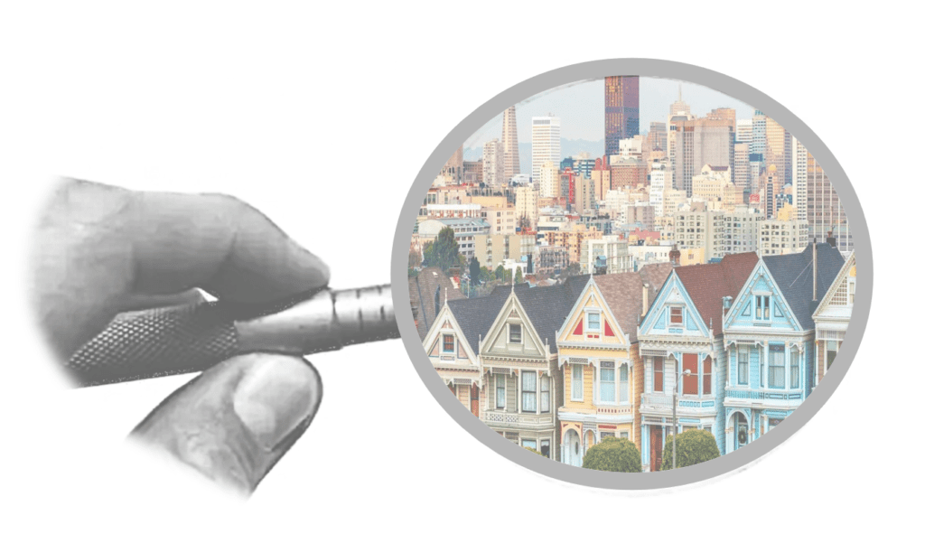 A magnifying glass is held over the houses.
