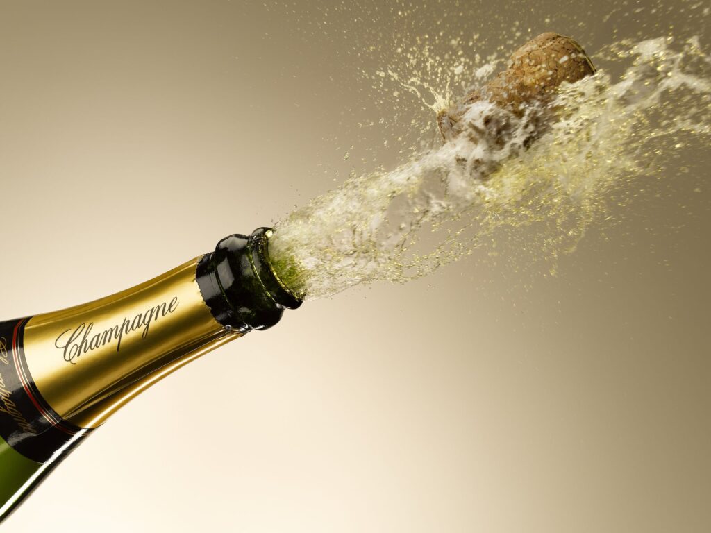 A champagne bottle is being opened with a cork.