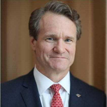 A man in suit and tie with short hair.